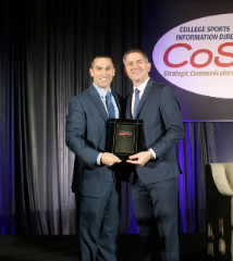 At the 2018 CoSIDA Convention, Chris Mitchell received the Warren Berg Award, presented annually to a CoSIDA College Division member who has made outstanding contributions to the field of sports information, and who has brought dignity and prestige to the profession. Rob Carolla, CoSIDA’s President during the 2017-18 academic year, presented Mitchell with the honor.